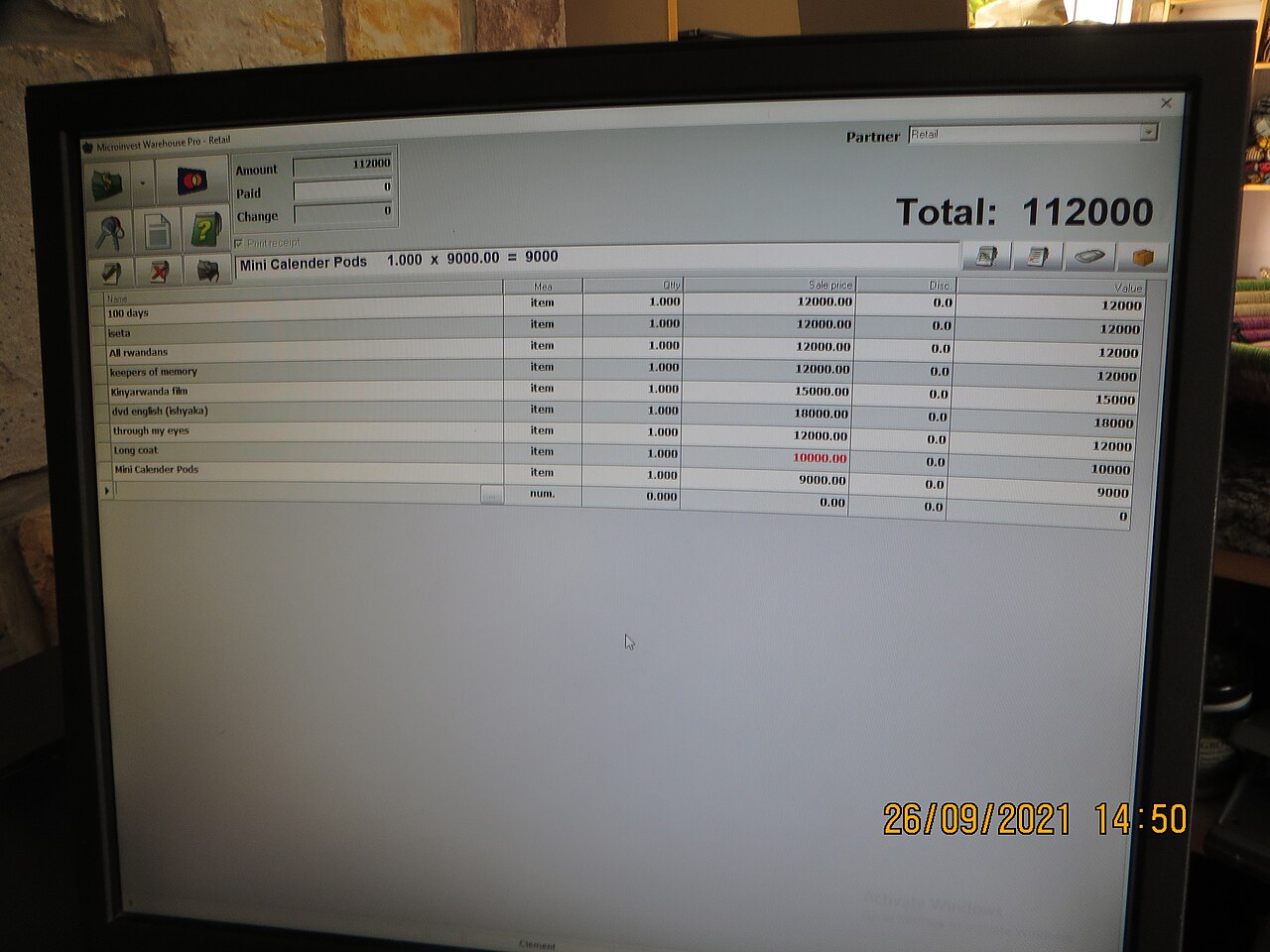 Spreadsheet of items and prices with a total on a monitor