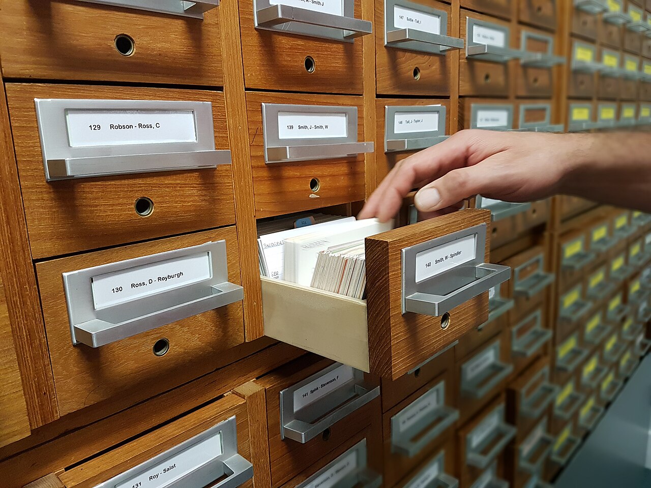 Hand in filing cabinet