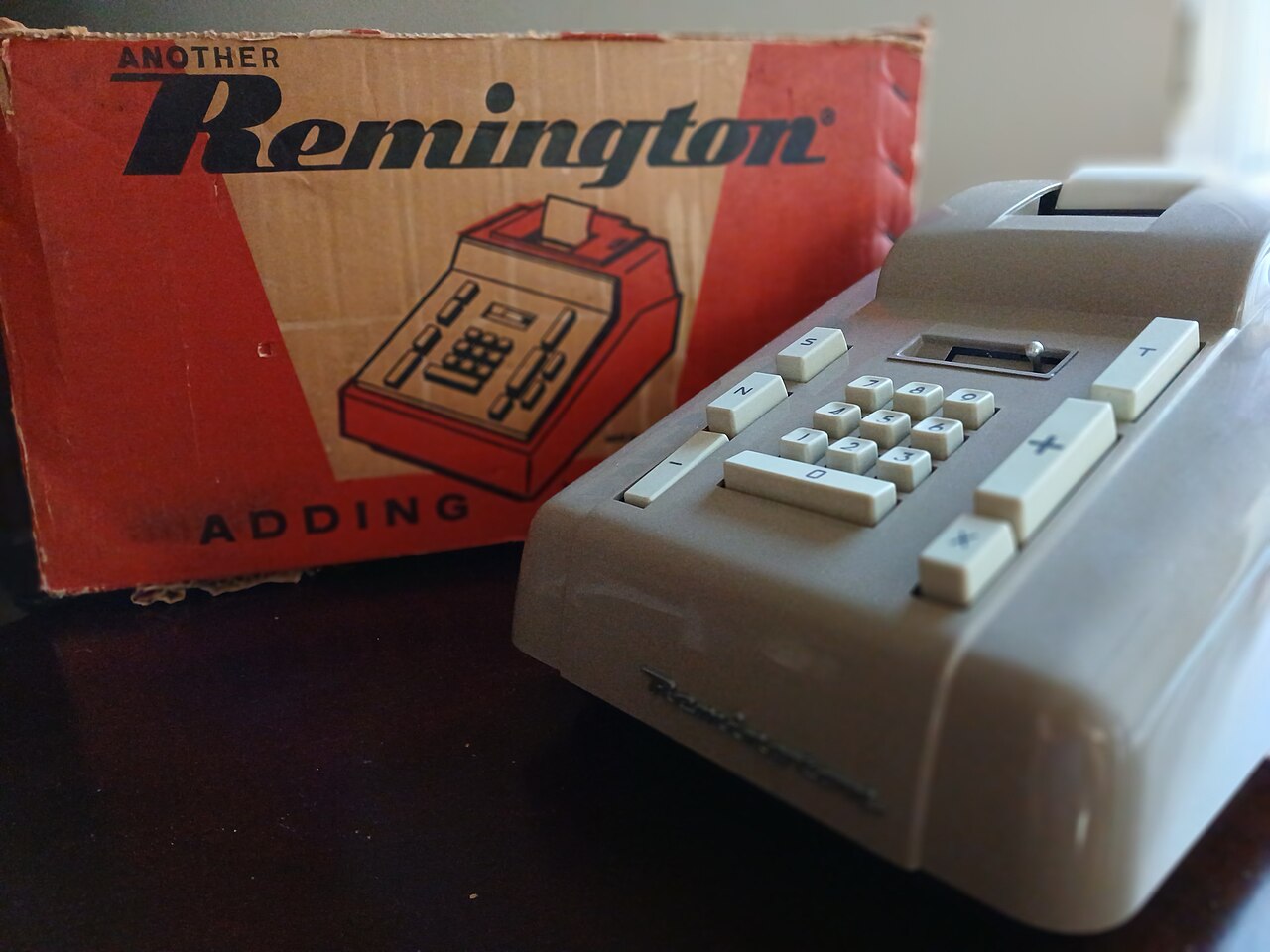 Remington adding machine beside its box